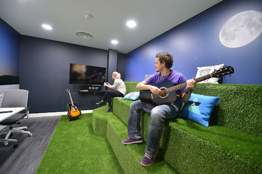people sitting on an Astroturf sofa